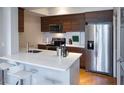 Modern kitchen with stainless steel appliances, white countertops, and wood cabinets at 2161 Peachtree Ne Rd # 605, Atlanta, GA 30309