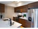 Modern kitchen featuring stainless steel appliances, sleek countertops and wood cabinets at 2161 Peachtree Ne Rd # 605, Atlanta, GA 30309
