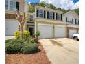Traditional two-story townhome featuring a two car garage, neutral paint, and well-manicured landscaping at 2241 Nottley Dr # 4, Marietta, GA 30066