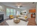 Bright living room featuring a fireplace, ceiling fan, and view of the outdoors at 2241 Nottley Dr # 4, Marietta, GA 30066