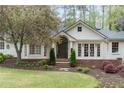 Inviting home exterior featuring a well-manicured lawn and blooming trees at 3038 Nancy Creek Nw Rd, Atlanta, GA 30327