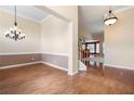 Formal dining room with hardwood floors and decorative lighting at 4955 Kingsbridge Ct, Powder Springs, GA 30127