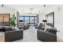 Living room showcasing stylish gray armchairs, modern lighting, and large windows with city views at 3475 Oak Valley Ne Rd # 1720, Atlanta, GA 30326