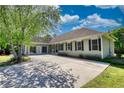 Spacious driveway leads to a beautiful home with a well-maintained lawn and mature trees at 72 Grayson New Hope Rd, Grayson, GA 30017