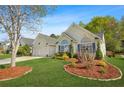 Beautiful home with a manicured lawn and landscaping, featuring large windows and a two-car garage at 205 E Skyline Vw, Dallas, GA 30157
