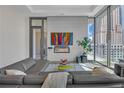Contemporary living room featuring a sleek fireplace and city views at 40 12Th Ne St # 903, Atlanta, GA 30309