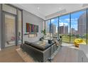 Modern living room showcasing contemporary decor, a fireplace, and city views at 40 12Th Ne St # 903, Atlanta, GA 30309