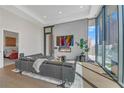 Elegant living room boasts a cozy fireplace, stylish decor, and city skyline views at 40 12Th Ne St # 903, Atlanta, GA 30309