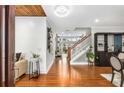 Inviting foyer features wood floors, shiplap accent wall, and staircase leading to upper level, creating a warm entrance at 501 Blackberry Ln, Canton, GA 30115