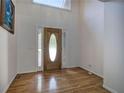 Bright foyer featuring a wooden front door with sidelights and beautiful hardwood flooring at 5894 Highway 20 Ne, Cartersville, GA 30121