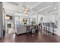 Spacious living room with coffered ceiling, fireplace, and open floor plan flowing into the kitchen and dining area at 725 Mcwilliams Se Rd, Atlanta, GA 30315