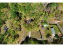 Aerial view of home on a lush lot surrounded by mature trees at 7771 A C Smith Rd, Cumming, GA 30028