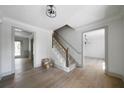 Bright foyer with hardwood floors, staircase, and classic trim at 7771 A C Smith Rd, Cumming, GA 30028
