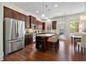 Modern kitchen with stainless steel refrigerator, kitchen island with seating, and a dining area at 2808 Broughton Se Ln, Atlanta, GA 30339