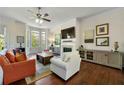 Bright living room featuring a fireplace, bay windows, and hardwood floors at 2808 Broughton Se Ln, Atlanta, GA 30339