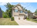 Traditional two-story home with neutral siding and a well-kept lawn on a partly cloudy day at 362 Lanier Ct, Hiram, GA 30141