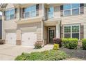 Inviting home featuring a covered front porch and attached two-car garage with well-maintained landscaping at 362 Lanier Ct, Hiram, GA 30141