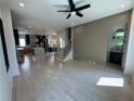 Open-concept living area showcasing hardwood floors, a modern staircase, and seamless kitchen access at 3960 Clairmont Rd # 2, Chamblee, GA 30341