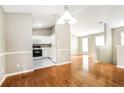 Open floor plan flows from dining area into kitchen with white cabinets at 4153 Island View Ct, Decatur, GA 30034