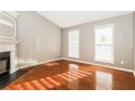 Bright living room features hardwood floors, a fireplace, and large windows at 4153 Island View Ct, Decatur, GA 30034
