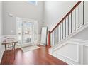 Bright foyer with hardwood floors, staircase, and a view of the front door at 3861 Sunbridge Dr, Snellville, GA 30039