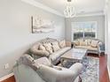 Elegant living room featuring luxurious sofas, a painting and a window at 3861 Sunbridge Dr, Snellville, GA 30039