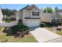 Charming two-story home with attached two-car garage, concrete driveway, and well-maintained landscaping at 507 Oakleaf Ct, Acworth, GA 30102