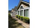 Inviting exterior view showcasing manicured shrubbery, coordinated architectural elements, and a walkway at 220 Rehobeth Way, Fayetteville, GA 30214
