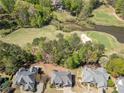 Stunning aerial view showcasing the home's proximity to a lush golf course and serene surroundings at 3531 Vintage Trl, Woodstock, GA 30189