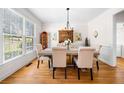 Bright dining room with hardwood floors, large window, and an elegant chandelier at 3531 Vintage Trl, Woodstock, GA 30189