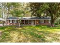 Traditional brick home featuring a lush green lawn and inviting front porch at 4220 Smith Rd, Loganville, GA 30052
