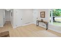 Light and bright entryway with wood floors, console table and coat closet at 1830 Mayfield Rd, Alpharetta, GA 30009