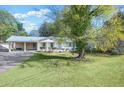Lovely one-story home with a carport and a lush green lawn at 1830 Mayfield Rd, Alpharetta, GA 30009