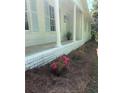 Beautifully landscaped yard with blooming azaleas lining the front porch foundation at 1830 Mayfield Rd, Alpharetta, GA 30009