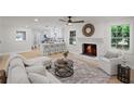 Open-concept living room with brick fireplace, hardwood floors and natural light at 1830 Mayfield Rd, Alpharetta, GA 30009