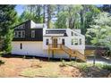 Modern home with a striking black and white exterior, complemented by a wooden deck and carport at 4544 Savage Ne Dr, Marietta, GA 30066