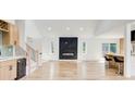 Open living space featuring a fireplace accent wall, modern light fixtures, and a kitchen bar at 4544 Savage Ne Dr, Marietta, GA 30066