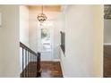 Bright entryway with wood floors, an elegant light fixture, and a staircase with iron railings at 1026 Township Sq, Alpharetta, GA 30022