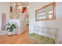 Bright foyer with hardwood floors, staircase, decorative mirror, and bench seating at 1187 Newbridge Ne Trce, Atlanta, GA 30319