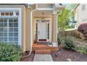 Inviting front porch with brick steps, elegant lighting, and lush landscaping at 1187 Newbridge Ne Trce, Atlanta, GA 30319