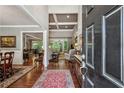 Open foyer leading to the living room with hardwood floors, elegant furnishings, and views of the dining area at 155 Palmer Oaks Ln, Marietta, GA 30068