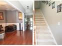 Inviting foyer featuring hardwood floors, staircase with carpet runner, and views into the adjacent living areas at 309 Daffodil Dr, Temple, GA 30179