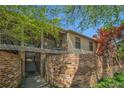 Brick apartment building featuring a balcony, brick wall, and lush landscaping at 3105 Colonial Way # F, Atlanta, GA 30341