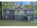 Charming split-level home with gray siding, brick foundation, and a welcoming front porch at 196 Wadley Nw St, Atlanta, GA 30314