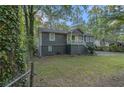 View of the two-story home, showcasing its well-maintained lawn and mature trees at 196 Wadley Nw St, Atlanta, GA 30314