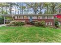 Beautiful home featuring a charming brick facade and well-maintained landscaping at 1998 Jordan Terrace Ne, Atlanta, GA 30345