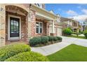 Charming two-story brick home featuring an arched entryway, and attached two car garage at 3597 Old Maple Rd, Johns Creek, GA 30022