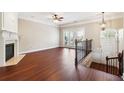 Spacious living room with hardwood floors, fireplace, and doors leading to a balcony at 4899 Seldon Se Way, Smyrna, GA 30080