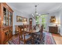 Elegant dining room featuring a large table, chandelier, and access to the outdoor area at 1180 Brookhaven Park Ne Pl, Brookhaven, GA 30319