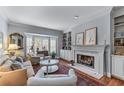 Bright living room featuring a fireplace, bay window, and hardwood floors at 1180 Brookhaven Park Ne Pl, Brookhaven, GA 30319